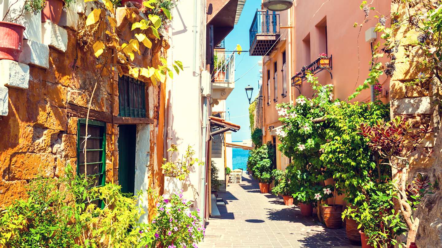 A narrow street with houses and plants in summer in Chania, Crete, Greece