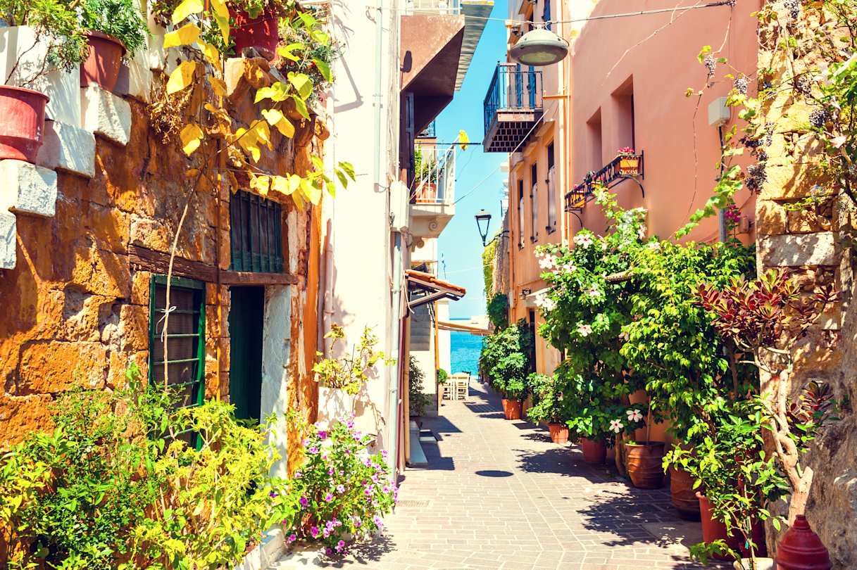 A narrow street with houses and plants in summer in Chania, Crete, Greece