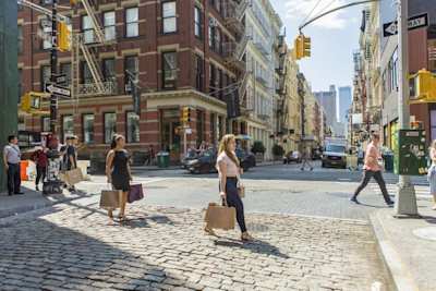 Shoppers walking with bags on a street in New York