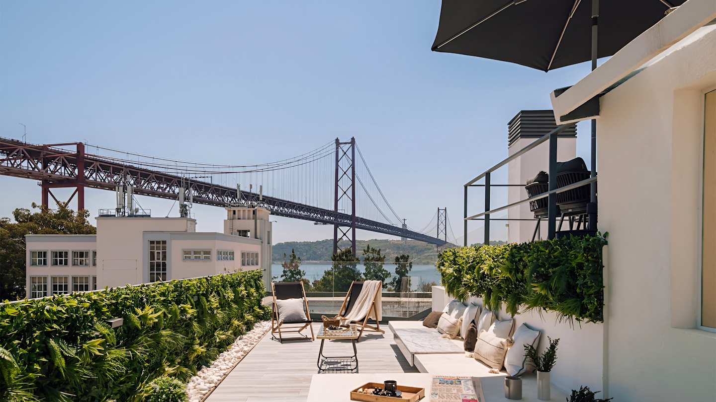 Views of the River Tagus and the Ponte 25 de Abril Bridge from the terrace in Ode to a City, a Plum Guide home in Lisbon