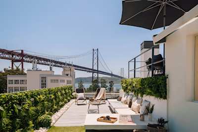Views of the River Tagus and the Ponte 25 de Abril Bridge from the terrace in Ode to a City, a Plum Guide home in Lisbon