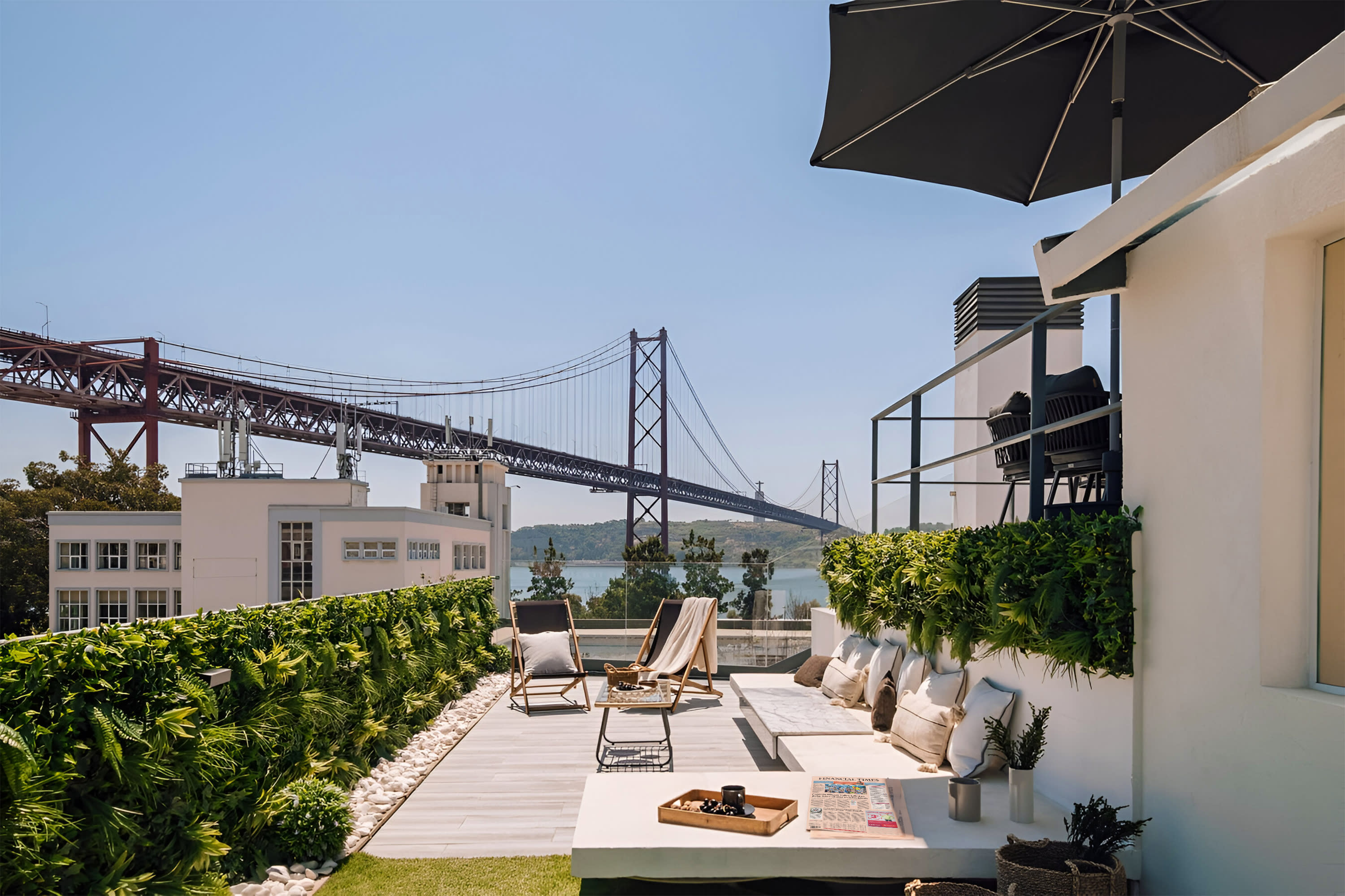 Views of the River Tagus and the Ponte 25 de Abril Bridge from the terrace in Ode to a City, a Plum Guide home in Lisbon