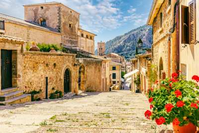 Cobbled street and stone houses in the old village of Pollenca, Mallorca
