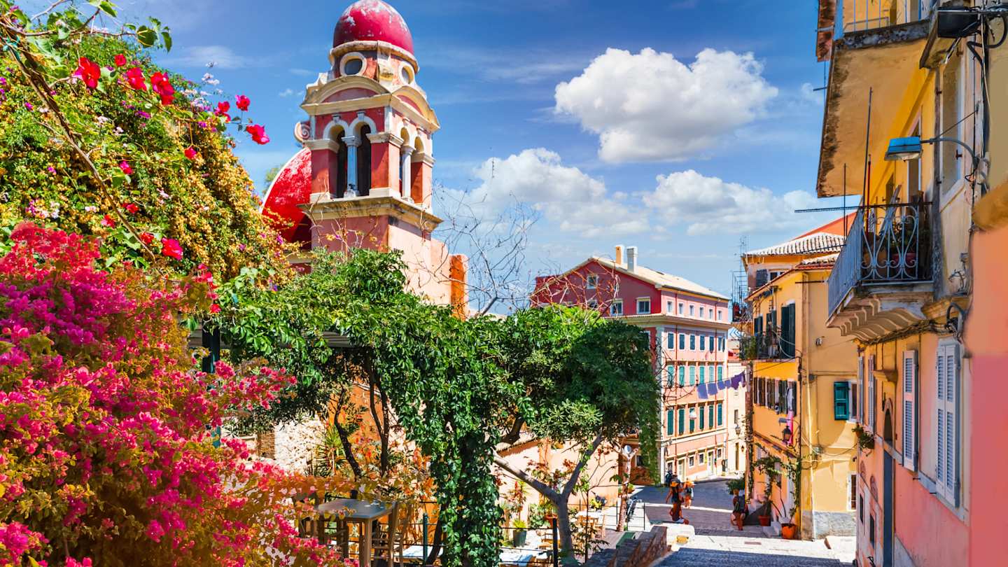 Colourful plants and buildings on a sunny day in Corfu Old Town, Greece
