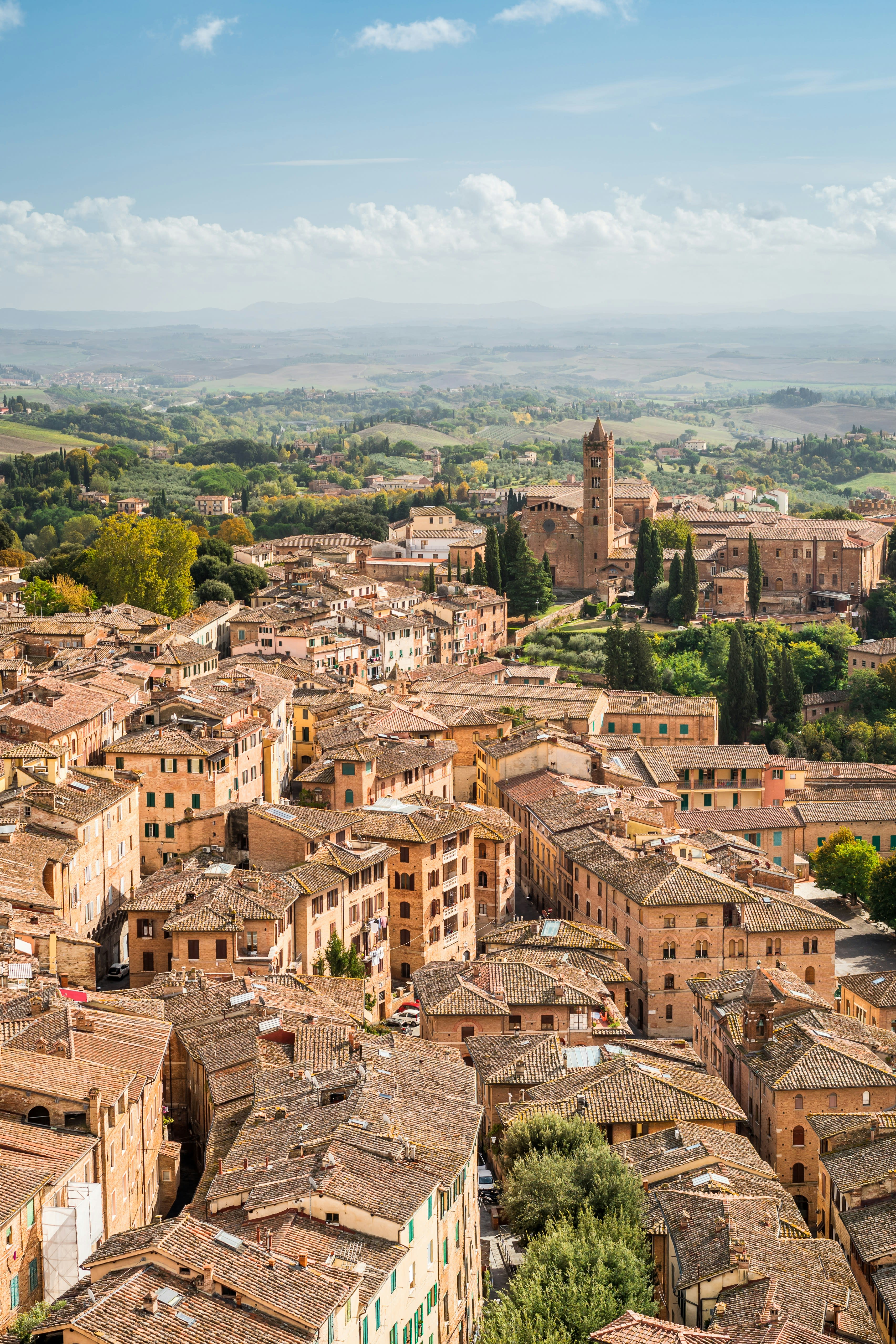 Scenic view of Siena's ancient buildings and rolling countryside, including the Duomo di Siena