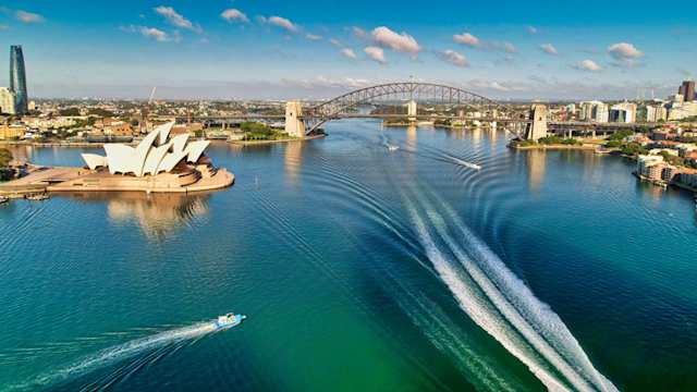 An aerial view of boats on the water by the Sydney Opera house at the harbour, Sydney, Australia