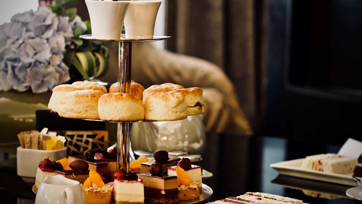 Afternoon tea stand full of scones and desserts