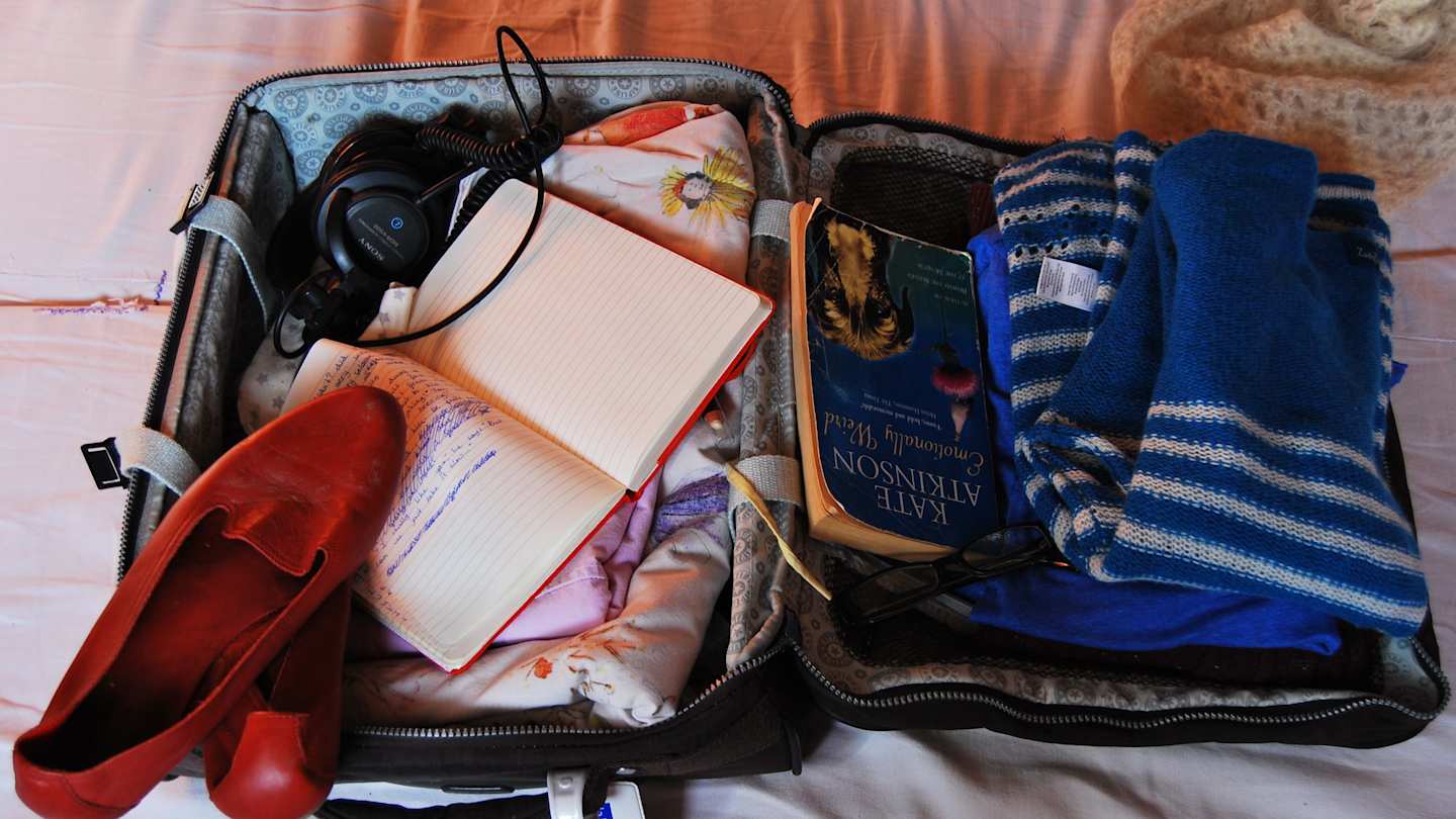Open suitcase packed with items
