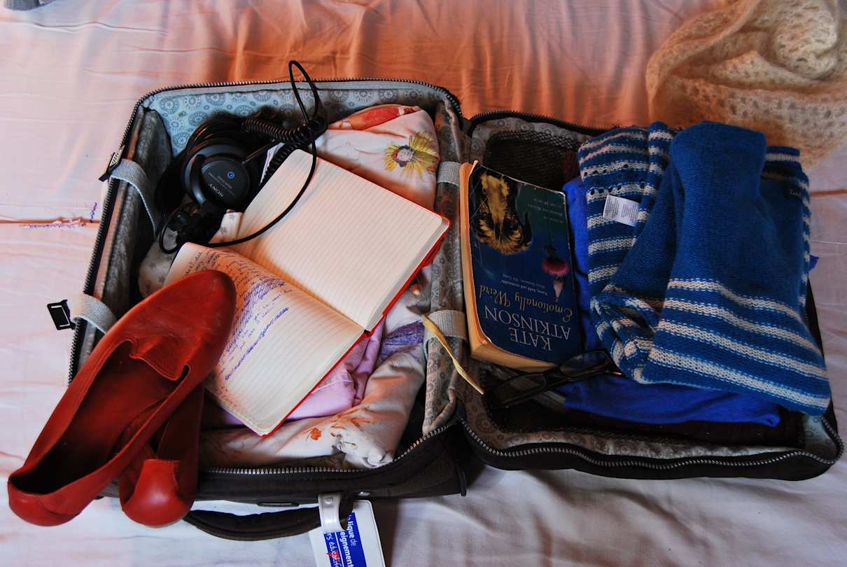 Open suitcase packed with items
