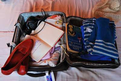 Open suitcase packed with items