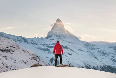 Person standing at the top of a snowy mountain in Zermatt, Switzerland