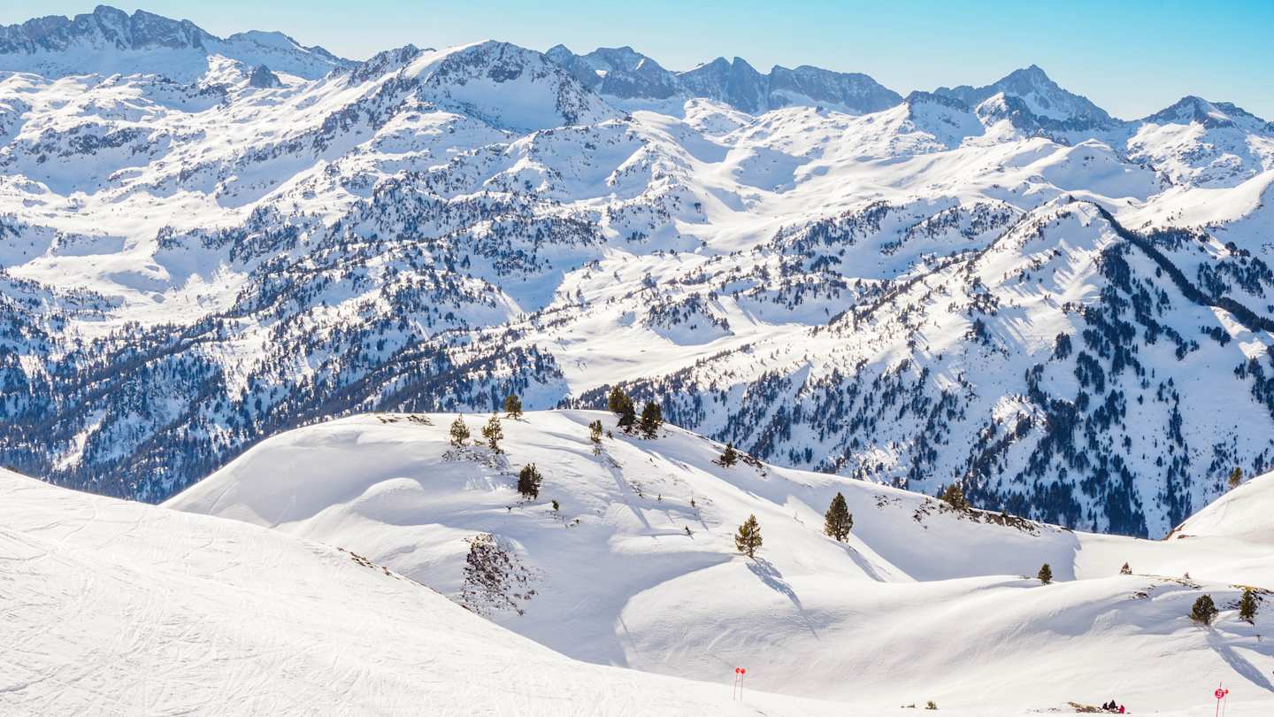 Mountain range with snowcapped peaks for skiing and blue skies, Baqueira-Beret
