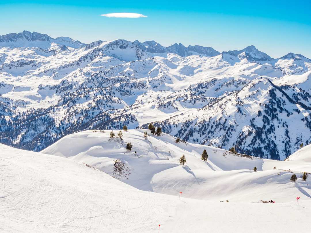 Mountain range with snowcapped peaks for skiing and blue skies, Baqueira-Beret