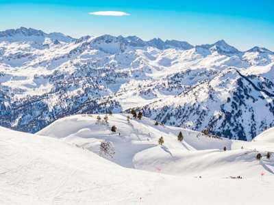 Mountain range with snowcapped peaks for skiing and blue skies, Baqueira-Beret