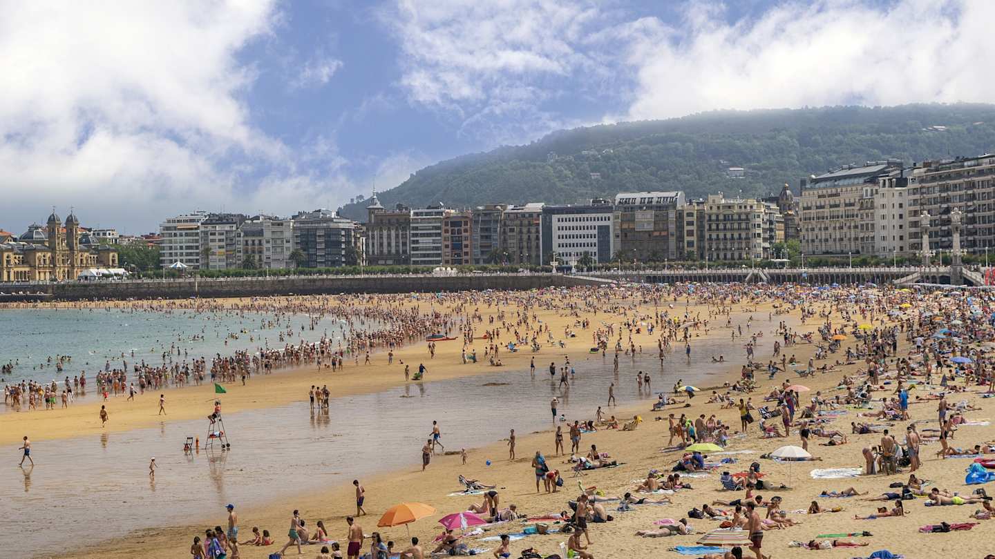 Beach filled with people in San Sebastian, Spain