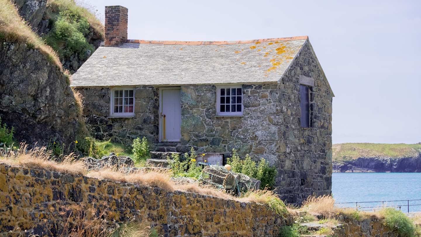 A brick coastal cottage by a lake, UK