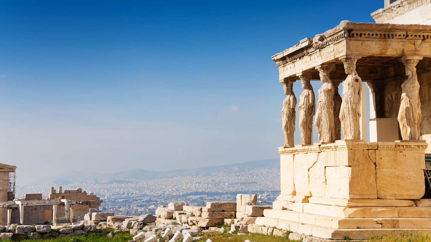 A view of the sculpted pillars on the Erechtheion overlooking the city from the Acropolis, Athens, Greece