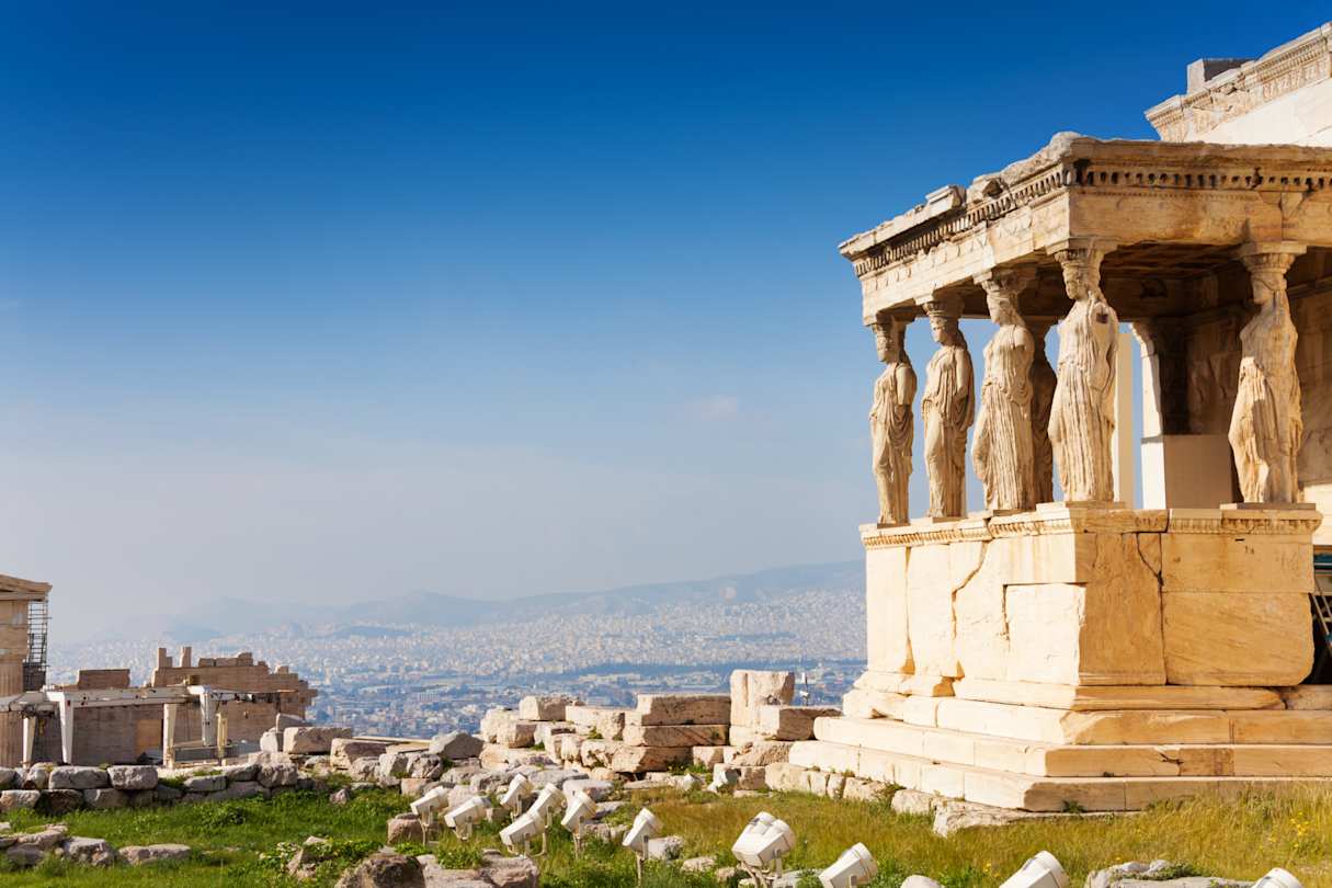 A view of the sculpted pillars on the Erechtheion overlooking the city from the Acropolis, Athens, Greece
