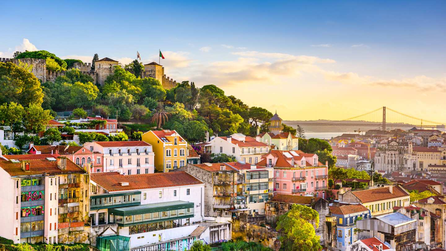 Lisbon's cityscape at dusk, including Castelo de S. Jorge and 25 de Abril Bridge, Lisbon, Portugal