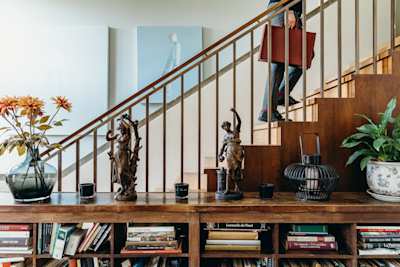 A Plum Guide Home Critic walking up the stairs of a home