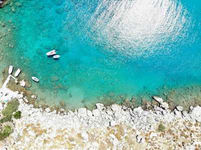 A bird's eye view of white boats in the clear water at St Paul's Bay, Rhodes, Greece