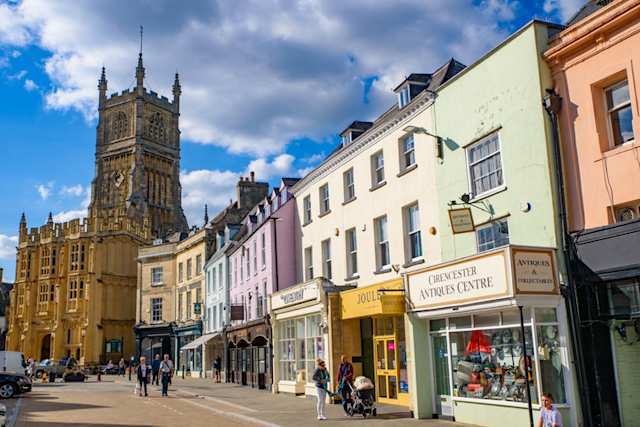 Street view of Cirencester and the church, a market town in the Cotswolds area, England, UK