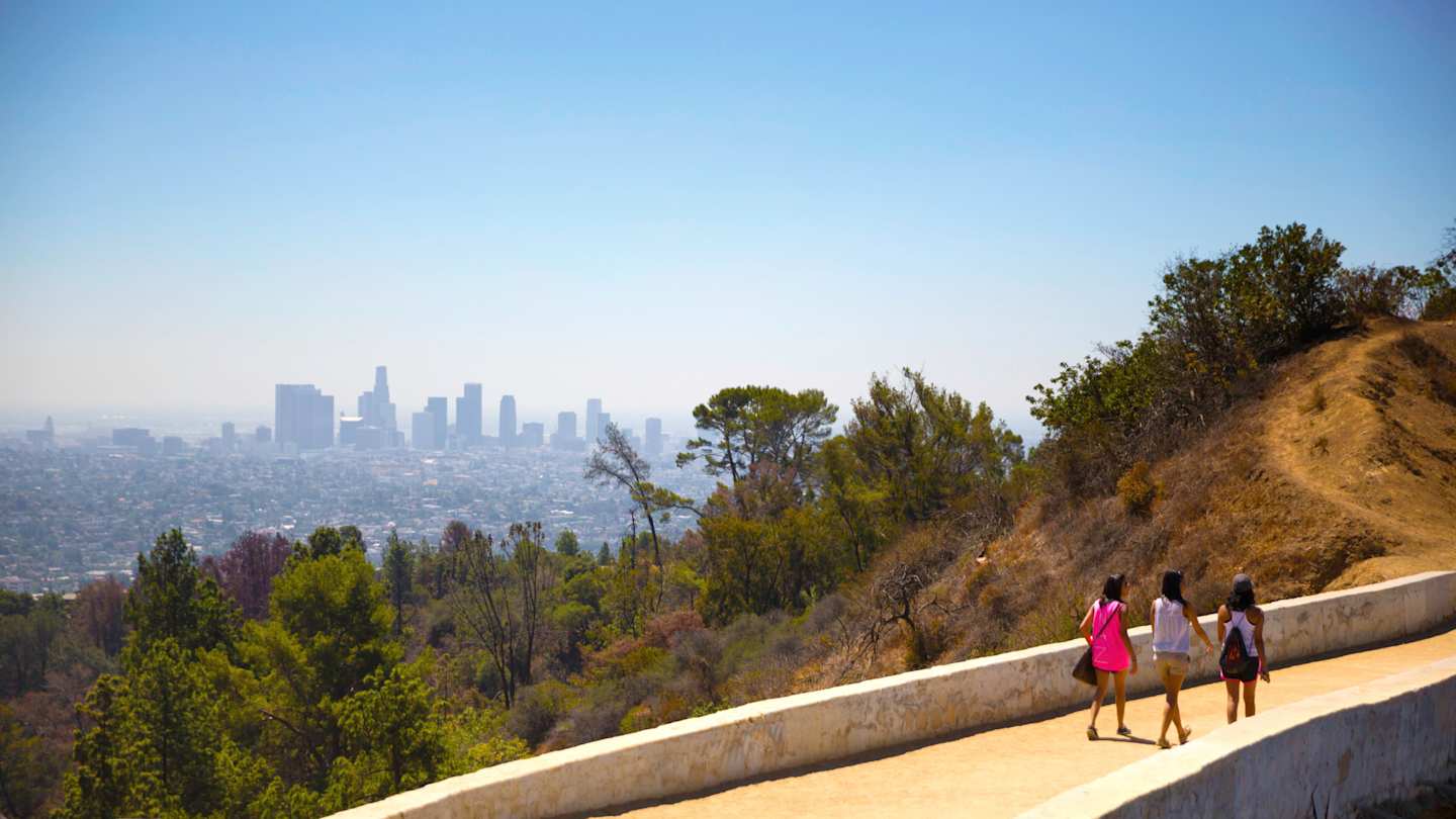 People walking along the Griffith Park Trail, overlooking the city, Los Angeles, USA