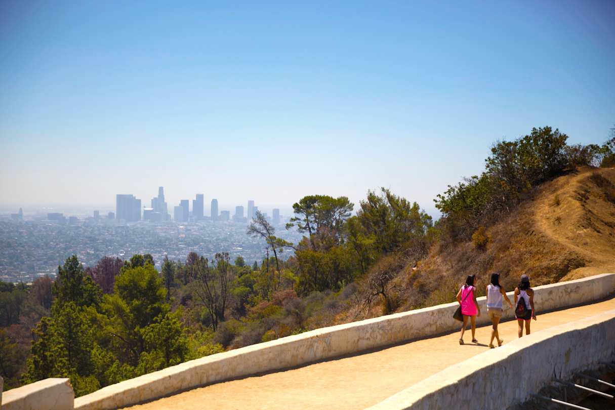 People walking along the Griffith Park Trail, overlooking the city, Los Angeles, USA