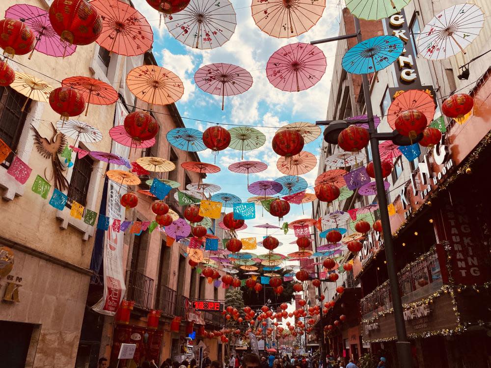 A view of colourful umbrellas as a canopy for a street in the city centre, Mexico City, Mexico