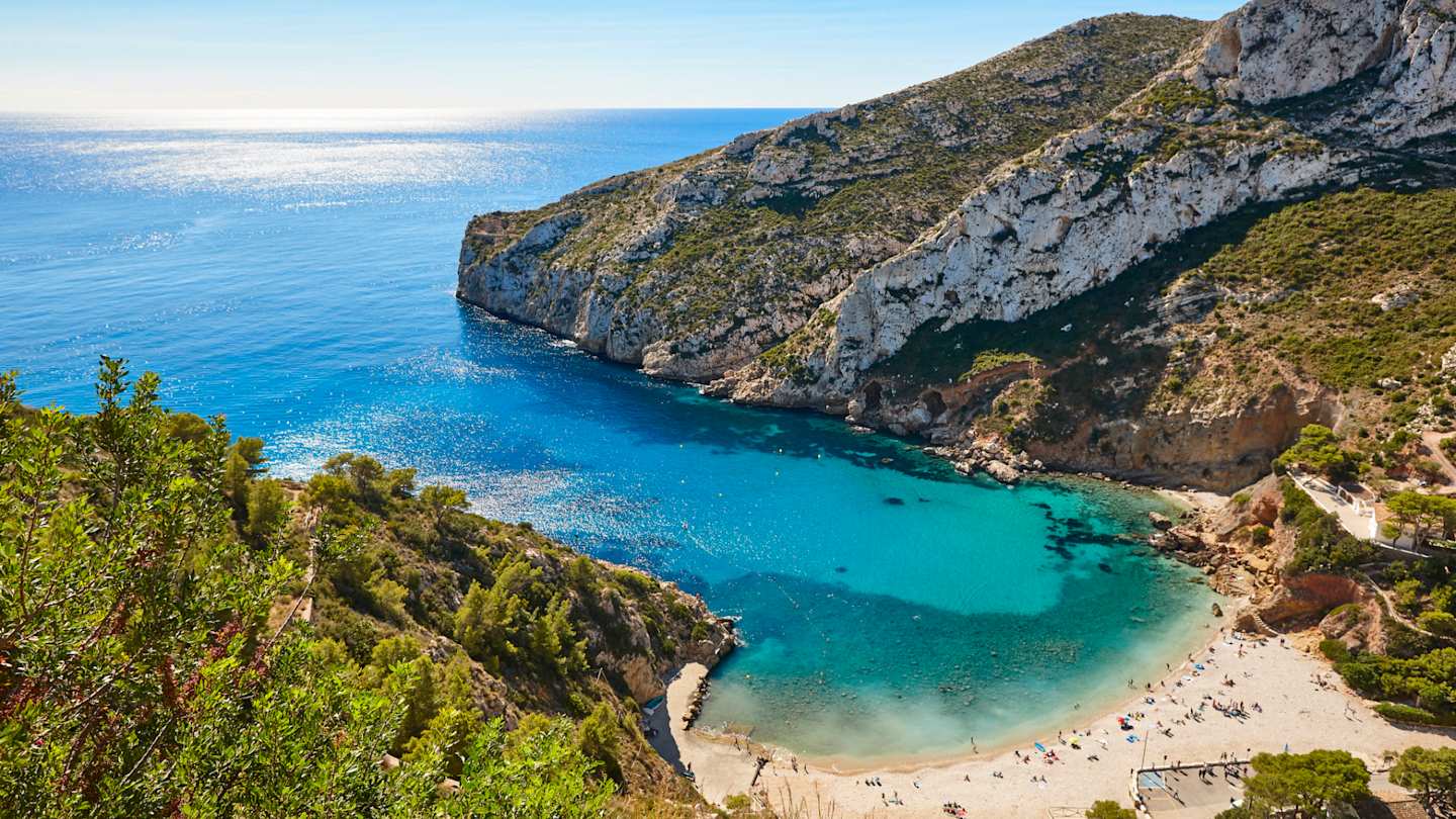Blue waters and rocky coastline of La Granadella Beach, Alicante
