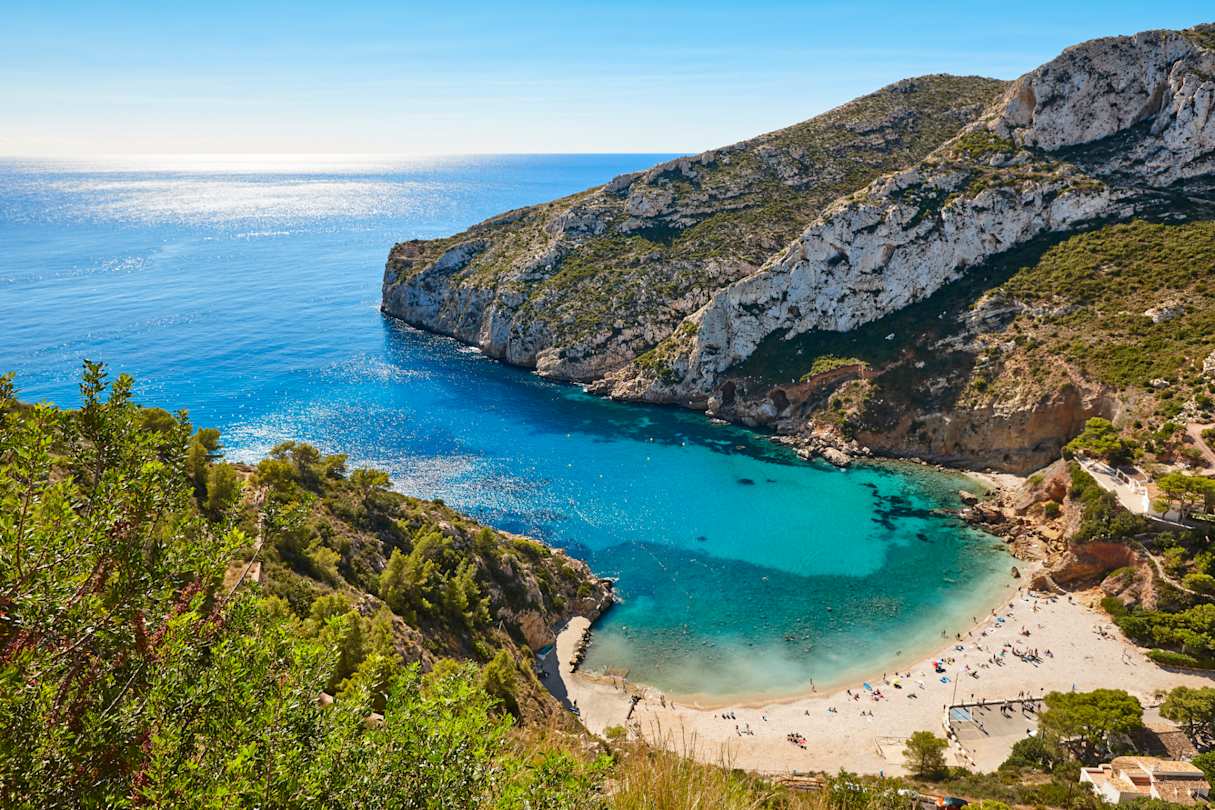 Blue waters and rocky coastline of La Granadella Beach, Alicante