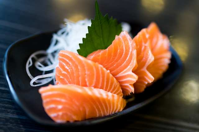 A close up view of slices of salmon sashimi