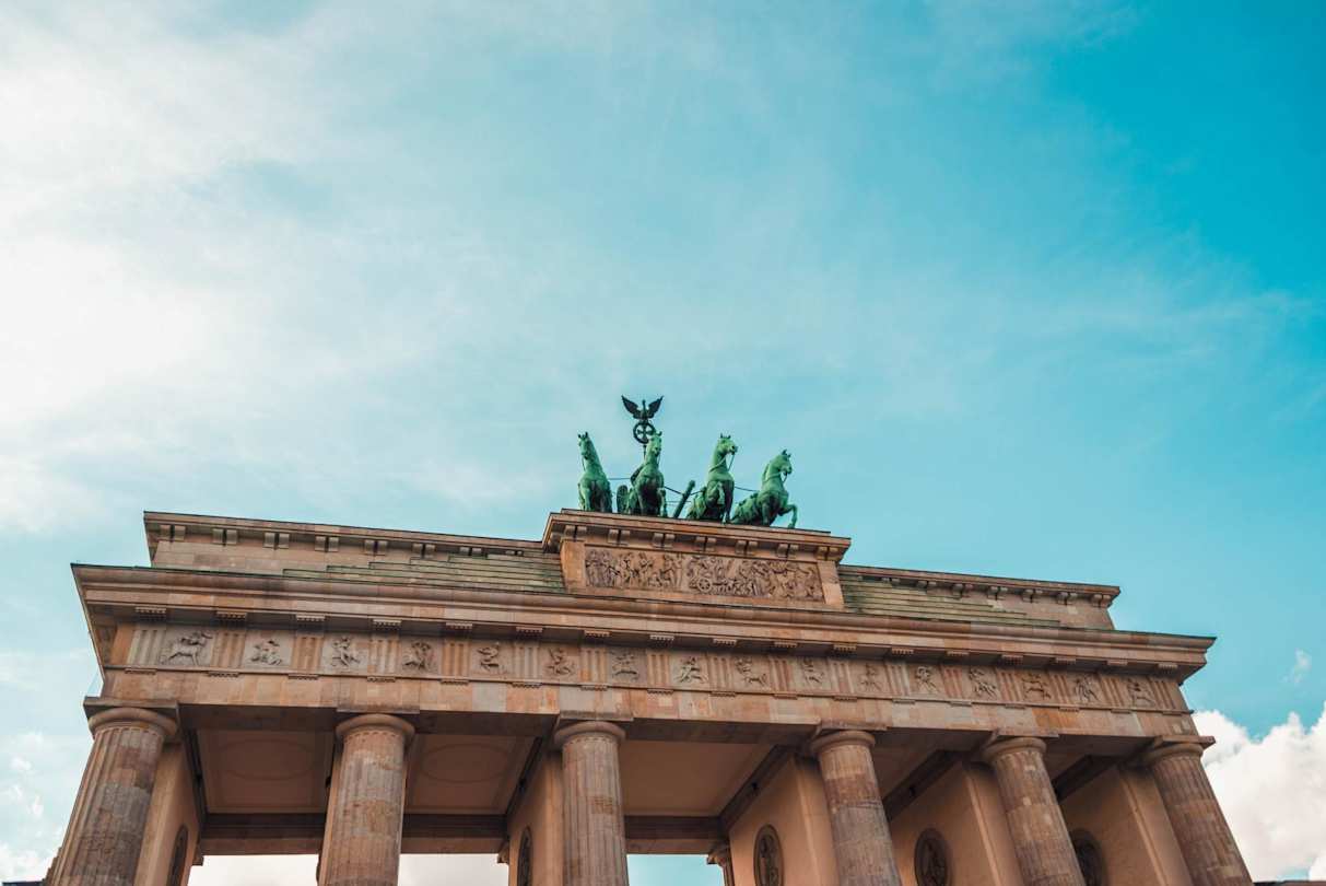 A low-angle view of the Brandenburg Gate against a blue sky in Berlin, Germany