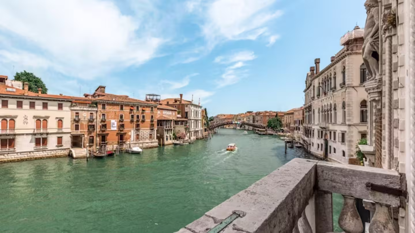 The Loredan's concrete balcony with views of the canal, bridge and gondolas, Venice
