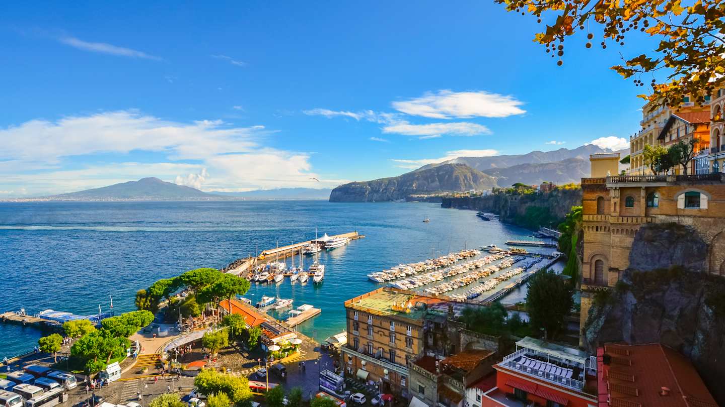 View of the port, Gulf of Naples, and historic old town from a cliff above the city on a sunny autumn day, Sorrento