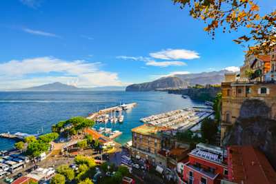 View of the port, Gulf of Naples, and historic old town from a cliff above the city on a sunny autumn day, Sorrento