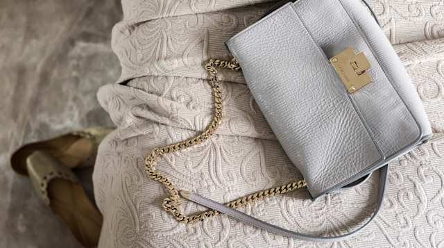 Handbag on bed in The Earl's Boutique, Plum Guide home