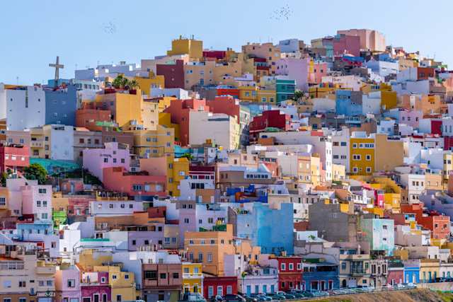 A view of clustered, colourful buildings on the side of a hill in Las Palmas, Gran Canaria, Spain