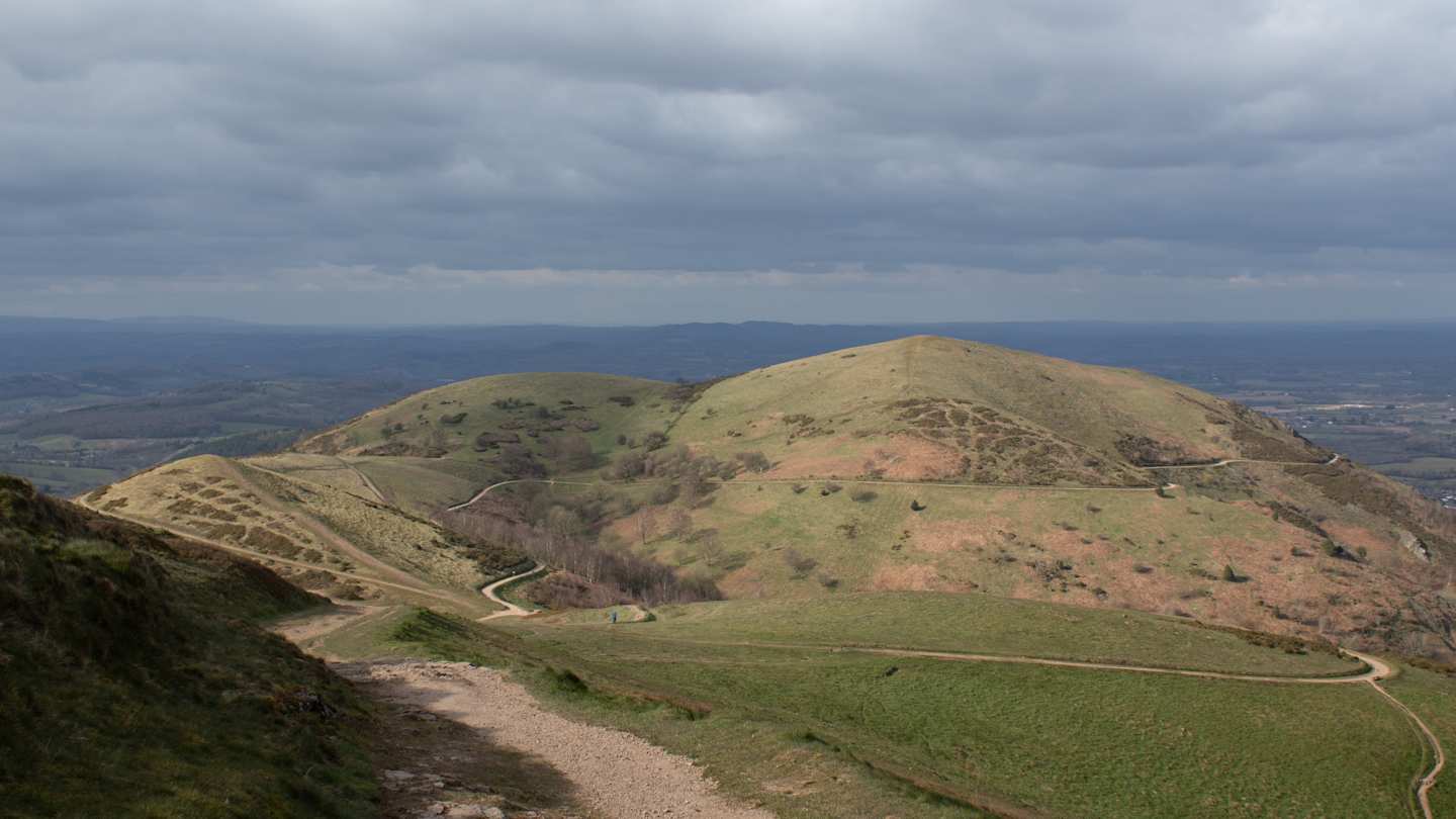 A view over green hills and meadows from the top of the Malvern Hills, Herefordshire, England, UK