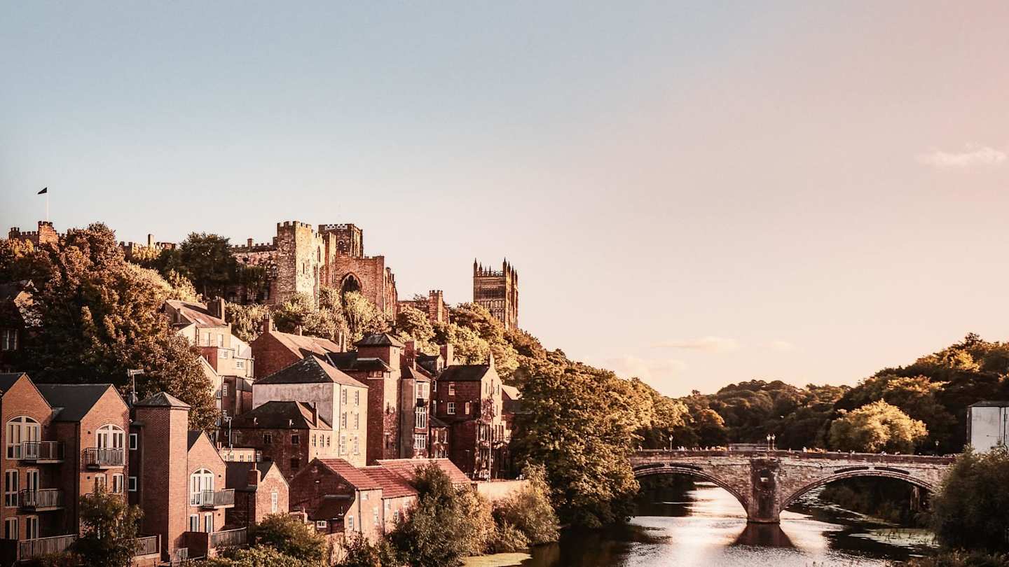 A view of houses and a cathedral next to the River Wear in Durham, England, UK