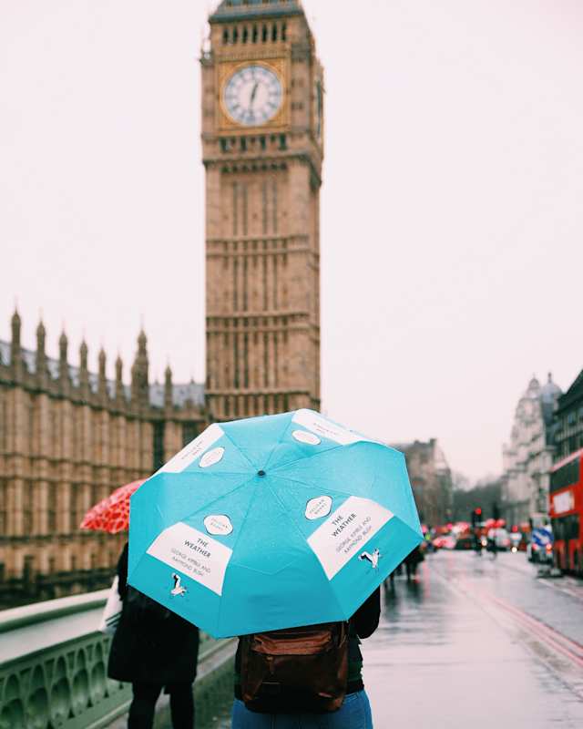 Person with an umbrella in the rain by Big Ben, London
