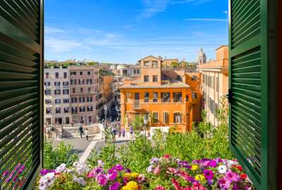 View through an open window with green shutters overlooking the Spanish Steps and the Piazza di Spagna in Rome, Italy