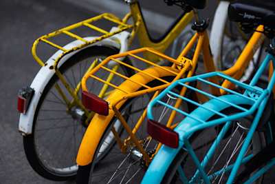A close up view of three colourful bicycles in a bike rack