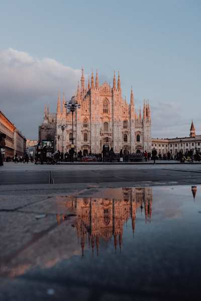 A view of the Duomo behind a crowd of people at sunset, Milan, Italy