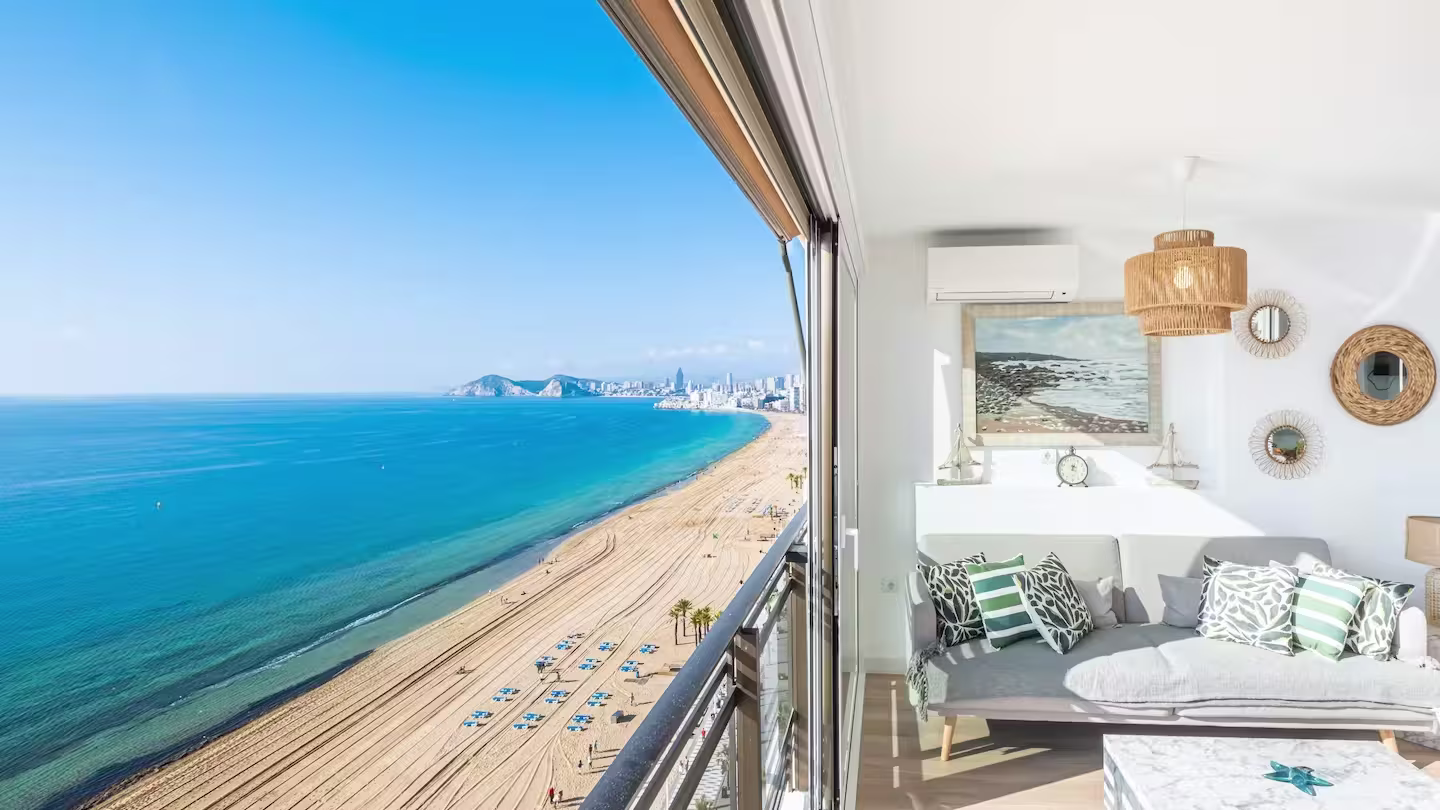 Boho style interior with a balcony overlooking the beach in Benidorm, Plum Guide home Wrapped in Sunshine near Alicante