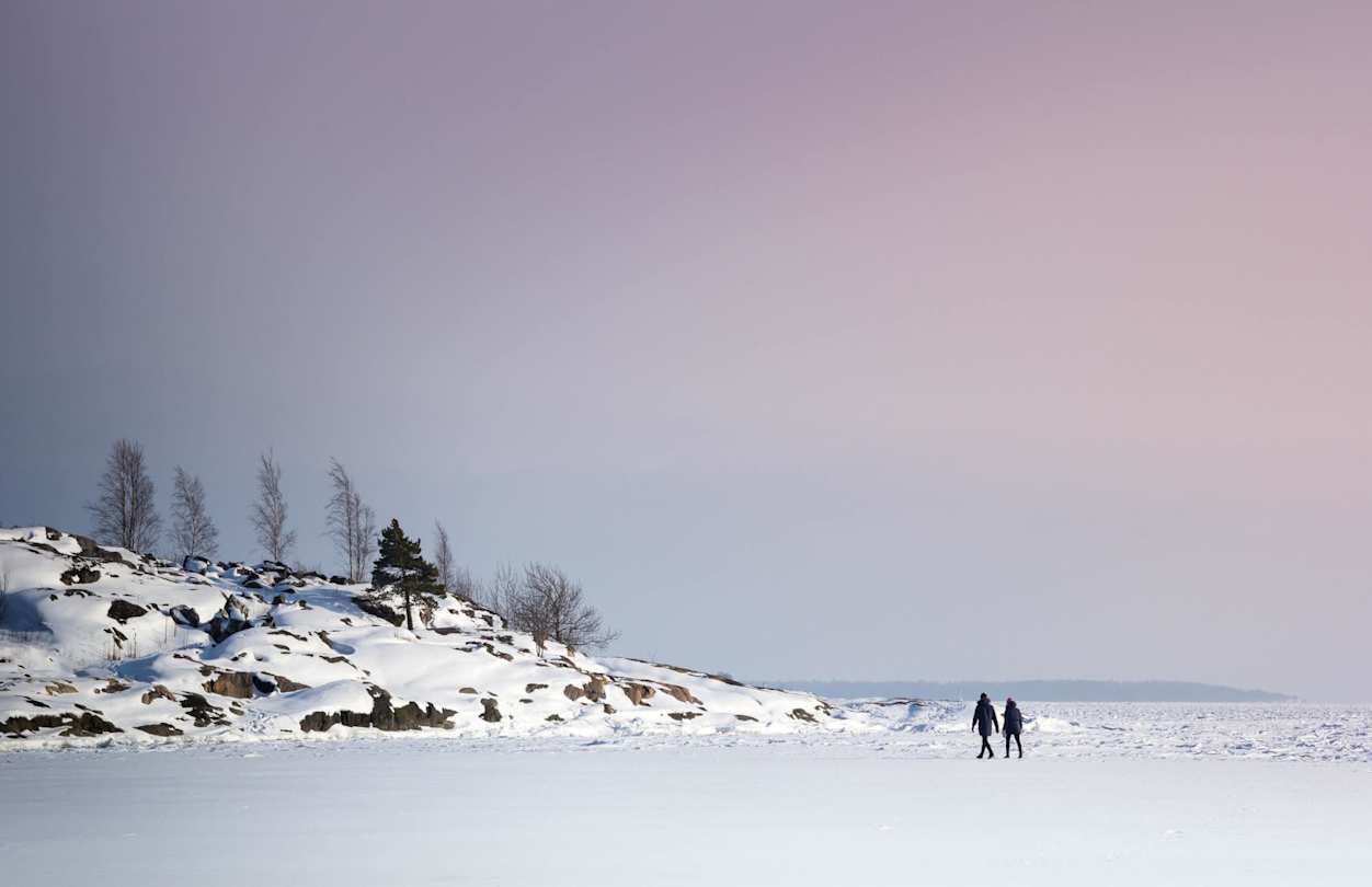 Two people strolling through large amounts of snow, Finland