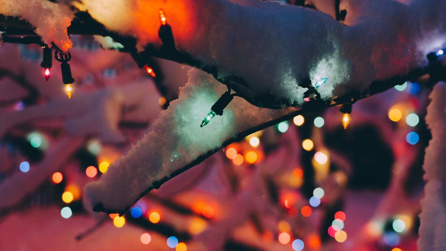 Close up of snow-covered lights on a Christmas tree