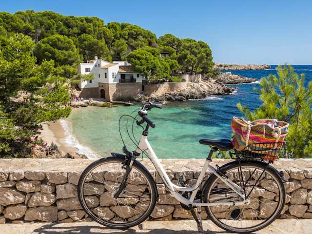 A white bicycle by a beach in Majorca, Spain
