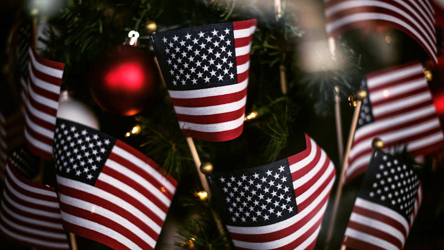 Small USA flags in front of a Christmas tree