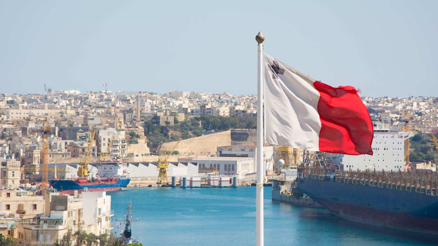 Flag of Malta with city of Malta in the background